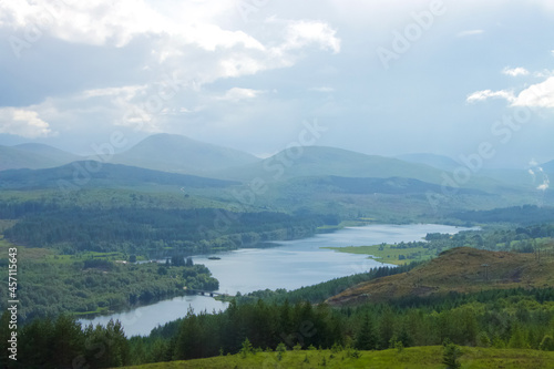 View of a Scottish loch in the Highlands with mountains and clouds