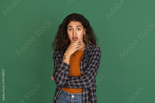 Traditional portrait of Latino beautiful girl isolated on green, vintage color studio background. Concept of human emotions, facial expression, natural beauty, diversity © master1305