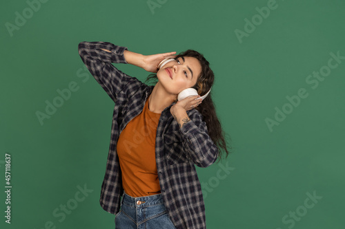 Portrait of Latino beautiful girl isolated on green, vintage color studio background. Concept of human emotions, facial expression, natural beauty, diversity © master1305
