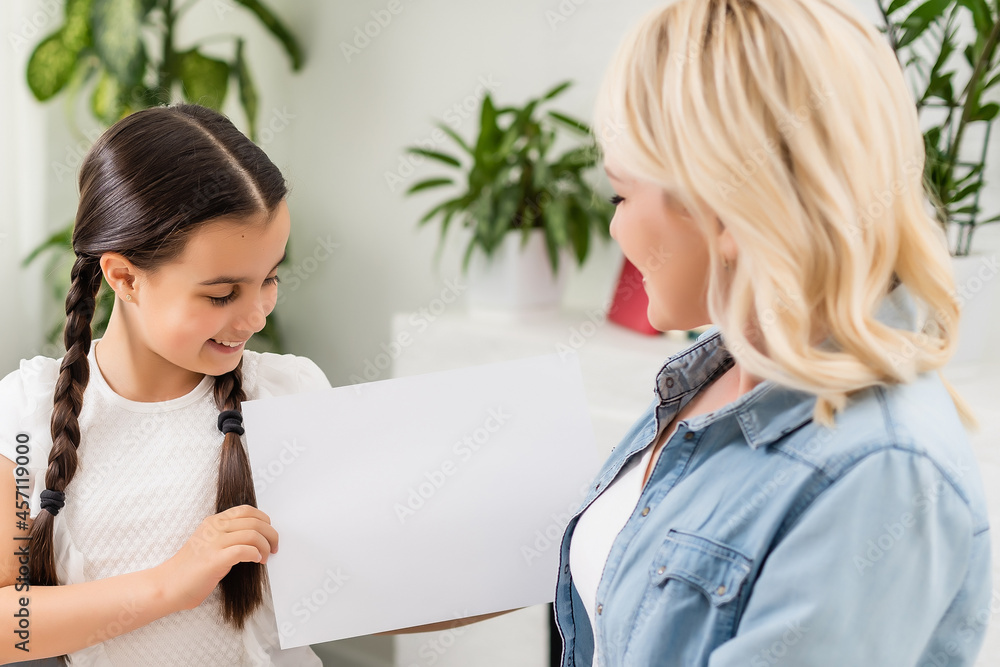 Cute little girl greeting her mother at home. Mother's day concept Cute little girl greeting her mother at home. Mother's day concept