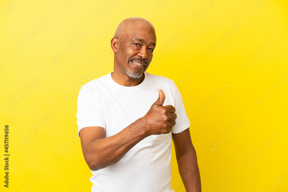 Cuban Senior isolated on yellow background proud and self-satisfied Cuban Senior isolated on yellow background proud and self-satisfied