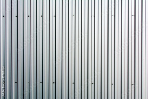 White metal corrugated fence. Background.