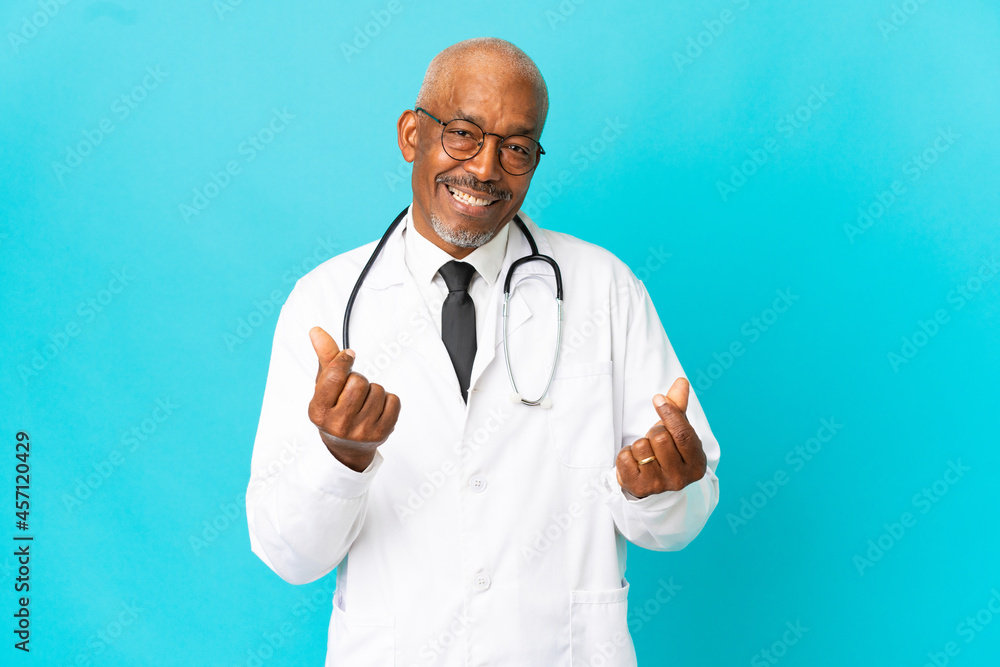 Senior doctor man isolated on blue background making money gesture Senior doctor man isolated on blue background making money gesture