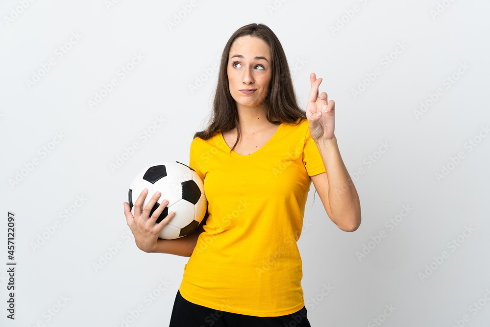 Young football player woman over isolated white background with fingers crossing and wishing the best Young football player woman over isolated white background with fingers crossing and wishing the best