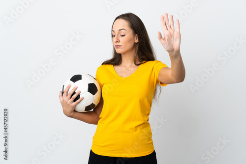 Young football player woman over isolated white background making stop gesture and disappointed © luismolinero