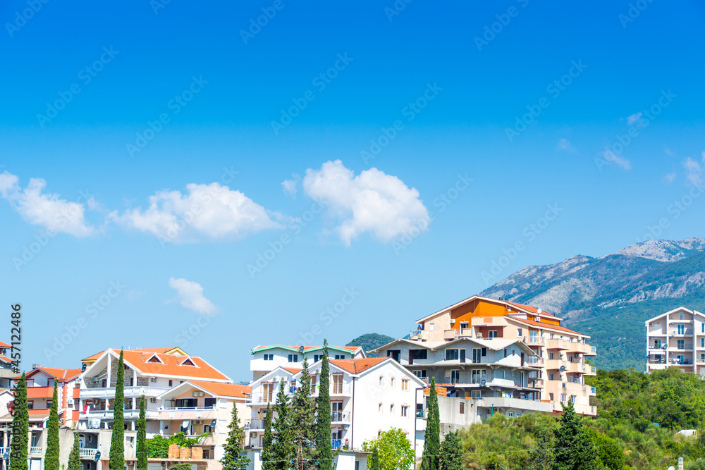 Herceg Novi, Montenegro, August 30, 2018. Beautiful modern white houses against the backdrop of mountains and greenery