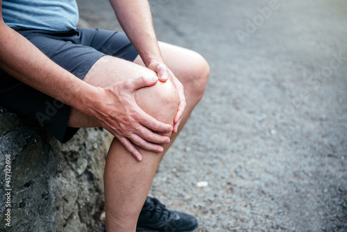 A man athlete suffering from knee ligamant tear photo