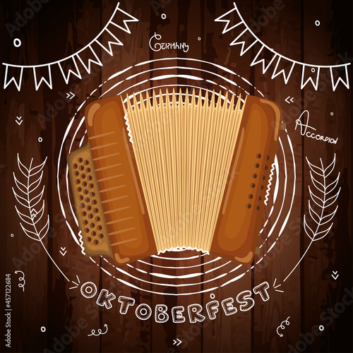 Accordion on a wooden background with chalk oktoberfest ornaments