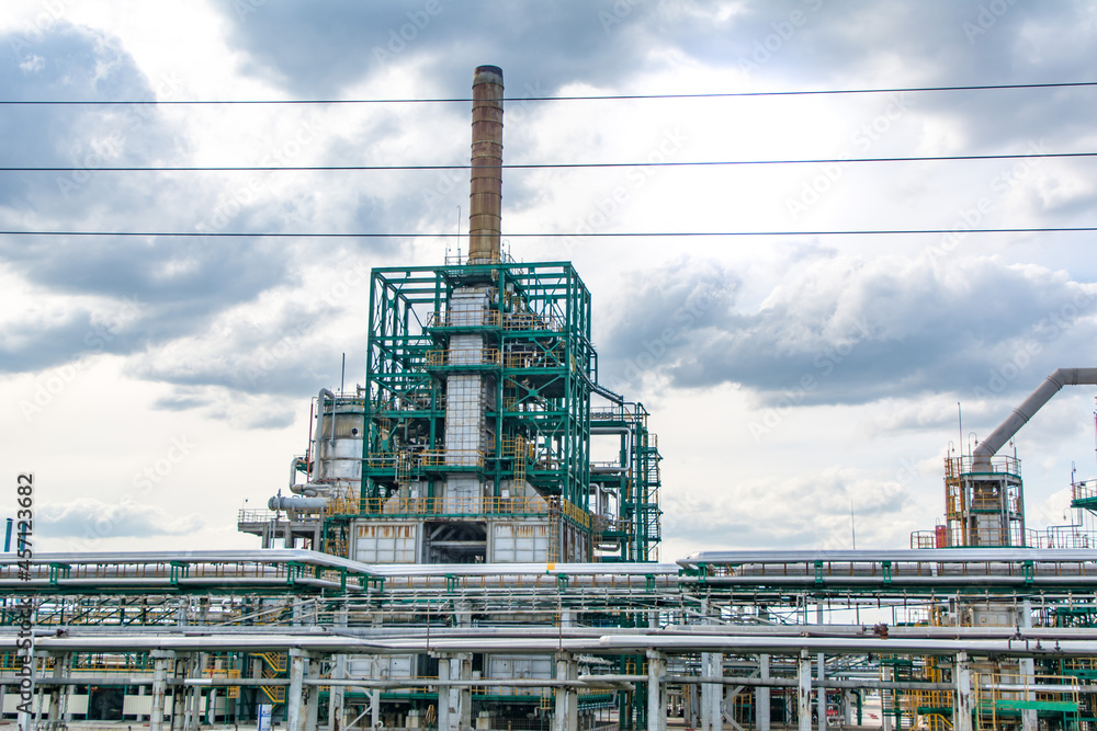 Fototapeta premium Route M6. Russia. May 23, 2021. Oil and gas refinery with pipeline steel fittings. A close-up view of an industrial oil refinery.