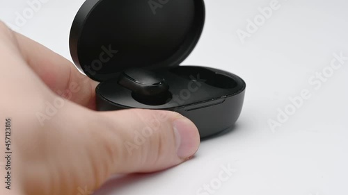 modern black wireless earbuds with bluetooth for smartphone isolated on white background.
