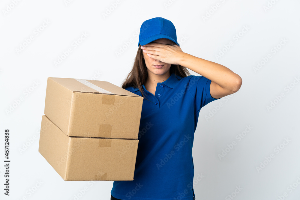 Young delivery woman over isolated white background covering eyes by hands Young delivery woman over isolated white background covering eyes by hands
