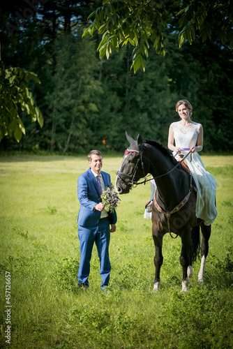Happy woman bride is ridding the horse