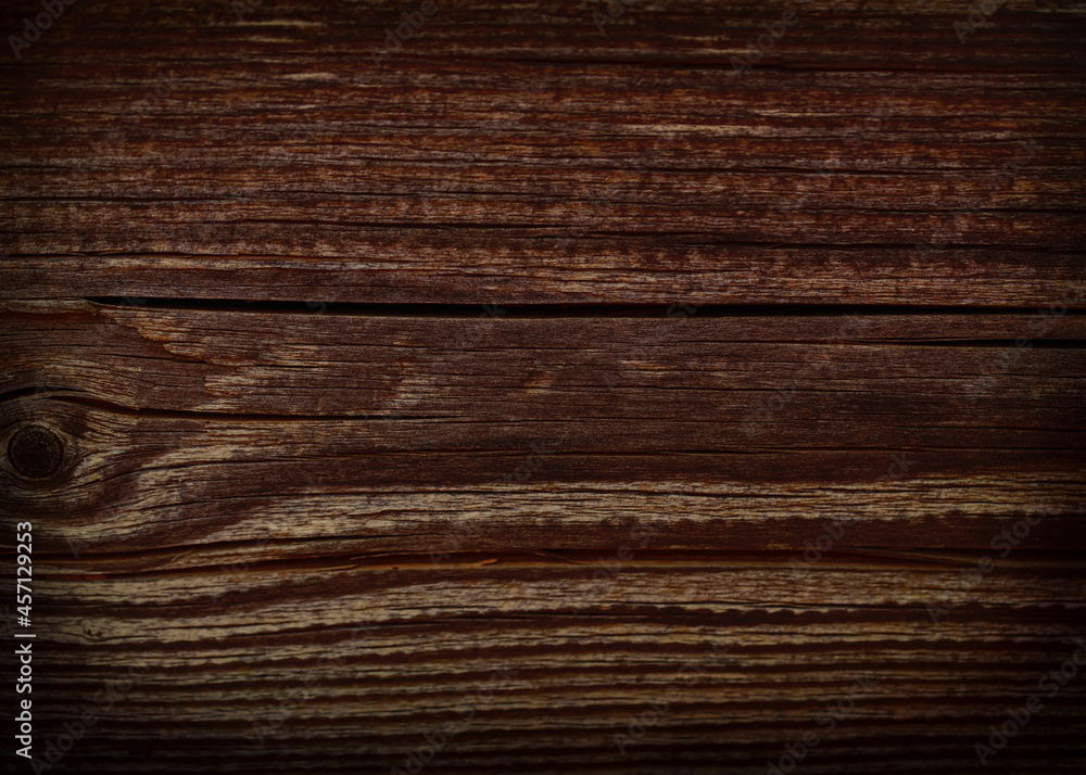 Fototapeta premium Dark brown textured wood background.