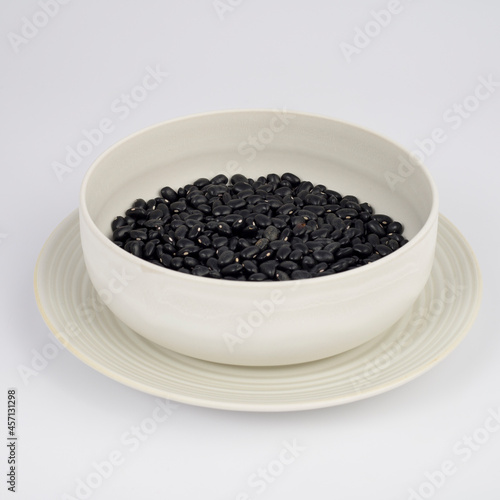 Black Beans on a plate on white background