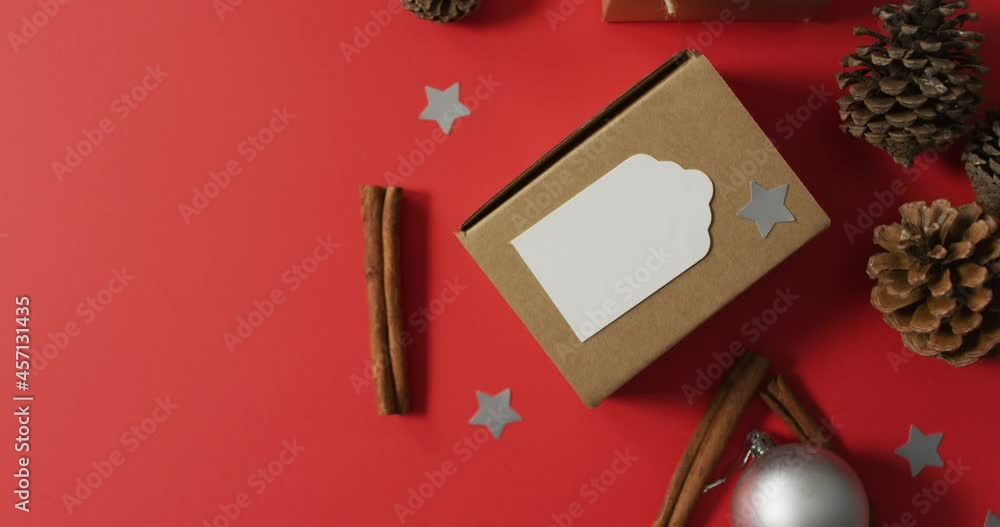 Christmas decorations with pine cones, cinnamon sticks and copy space on red background Christmas decorations with pine cones, cinnamon sticks and copy space on red background