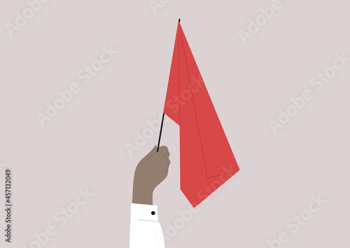 A hand waving a red flag, a warning sign