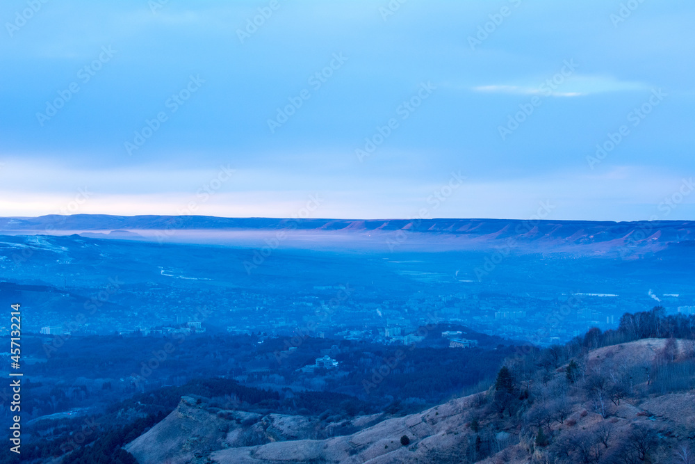 Kislovodsk, Russia. December 28, 2018. Evening view from a high mountain to the mountains and forest of Kislovodsk. Kislovodsk, Russia. December 28, 2018. Evening view from a high mountain to the mountains and forest of Kislovodsk.