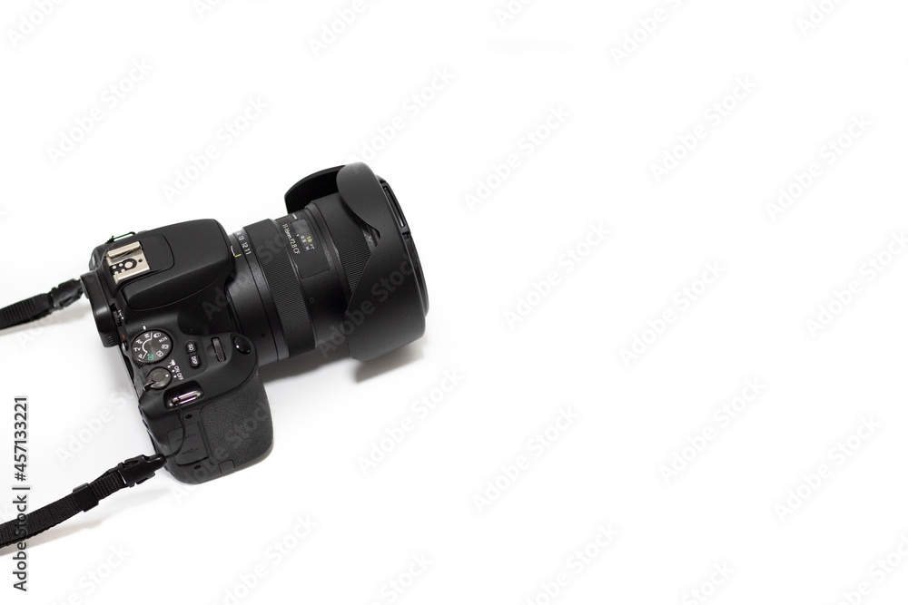 a photo camera with lens, on a white background. Copy space, selective focus, isolated on white