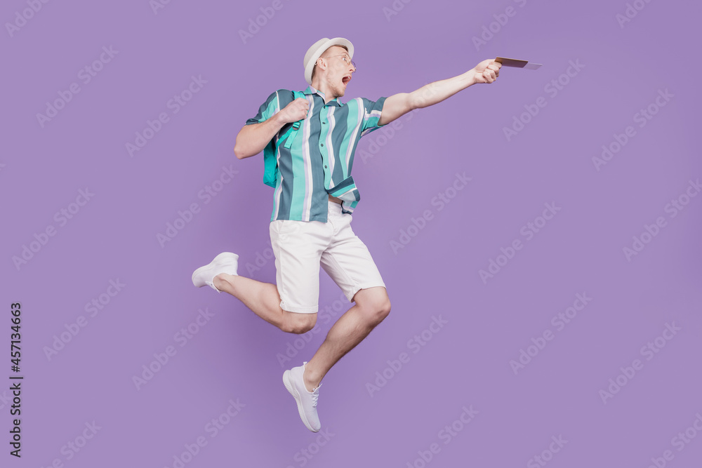 Profile portrait of crazy guy jump run hold tickets late flight check-in on purple background