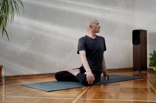 Energetic middle-aged man doing yoga poses.