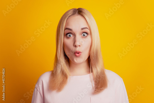 Portrait of pretty lady open mouth omg reaction look camera on yellow background