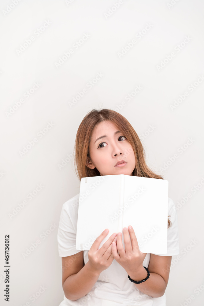 Young attractive asian student holding books in her arm on white background. School girl with a books to read for homework. Young attractive asian student holding books in her arm on white background. School girl with a books to read for homework.