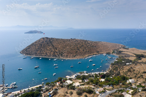 Fototapeta Naklejka Na Ścianę i Meble -  Aerial view of Bodrum's well-known holiday resort Gumusluk (Gümüşlük) bay and boats in the sea. TURKEY