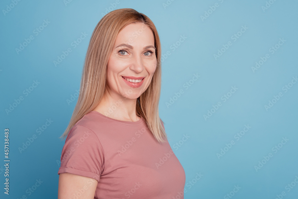 Obraz premium Profile side photo of young cheerful woman happy positive smile confident isolated over blue color background