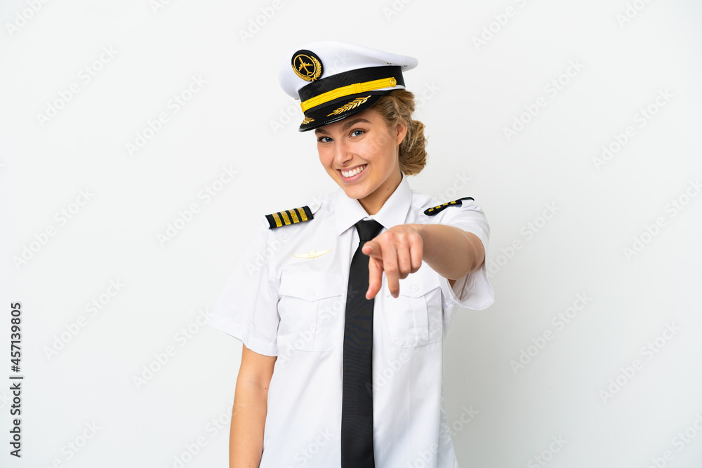 Airplane blonde woman pilot isolated on white background pointing front with happy expression
