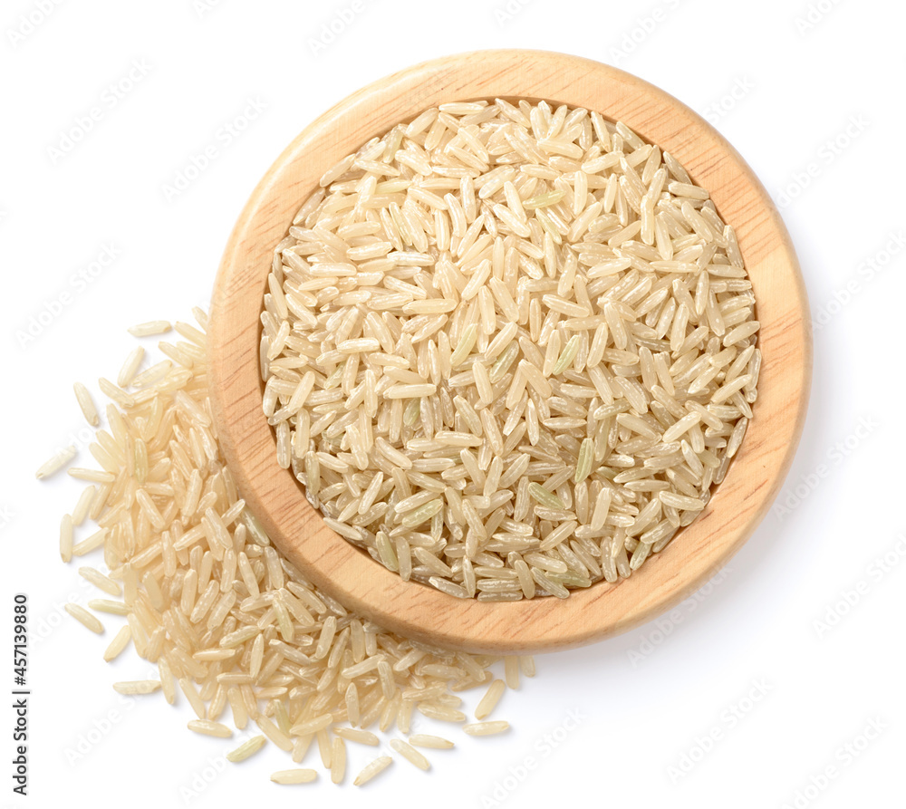 raw long brown rice in the wooden plate, isolated on the white background, top view