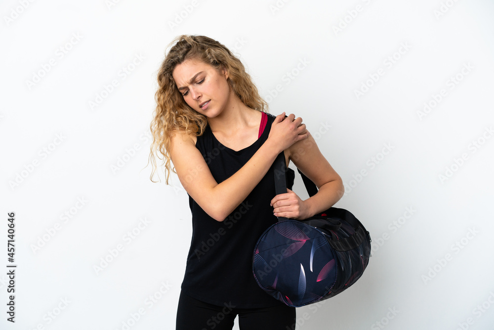 Young sport woman with sport bag isolated on white background suffering from pain in shoulder for having made an effort Young sport woman with sport bag isolated on white background suffering from pain in shoulder for having made an effort