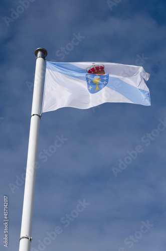 Galician flag waving against sky