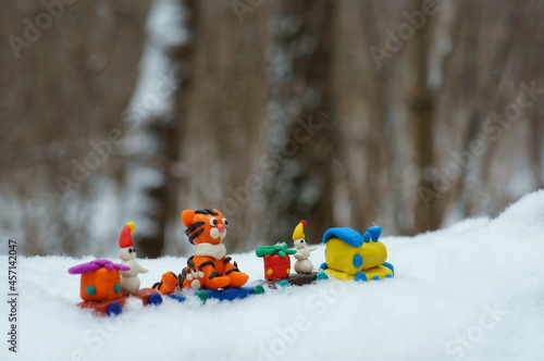 Toy train with fabulous toys. Tiger cub, snowman and Christmas gifts.