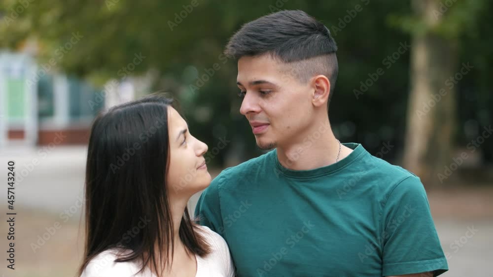 Smiling young couple standing, playing and talking to each other in summer Smiling young couple standing, playing and talking to each other in summer