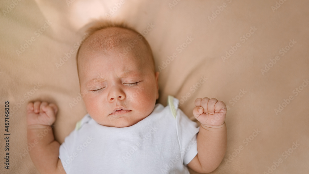 Childhood, care, motherhood, health, medicine, pediatrics concepts. Newborn baby sleeps on soft bed.            