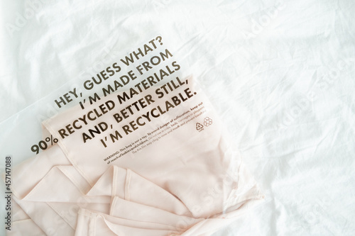 shirt in plastic bag with tag recycled materials and recyclable. zero waste concept.