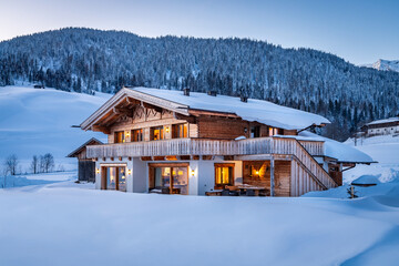Wooden chalet in the alps on a cold winter evening