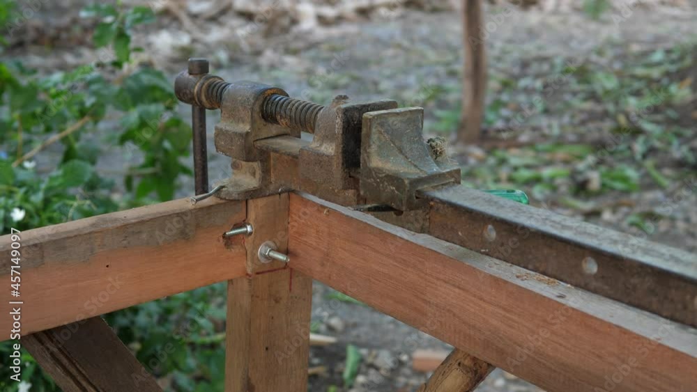 Close up of old metal rusty manual tools, equipment in working place of making timber furniture outdoor in nature background. Concept of wood carpentry, hobby, DIY in free time, vintage retro location Close up of old metal rusty manual tools, equipment in working place of making timber furniture outdoor in nature background. Concept of wood carpentry, hobby, DIY in free time, vintage retro location