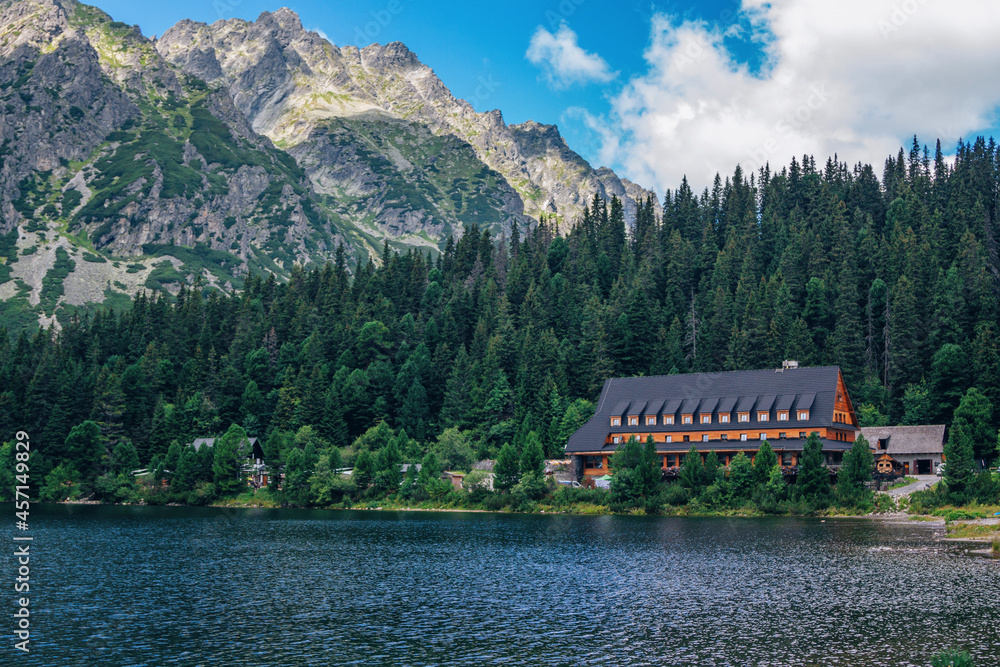 Beautiful summer landscape of High Tatras, Slovakia – Poprad lake, lush forest, mountains and white clouds on the sky