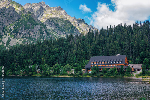 Beautiful summer landscape of High Tatras, Slovakia – Poprad lake, lush forest, mountains and white clouds on the sky