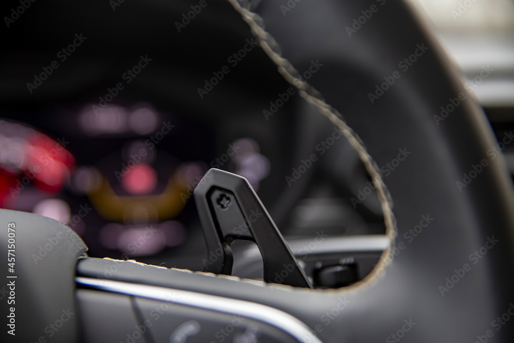 paddle shifter on steering wheel in a modern premium car. Speedshift close-up paddle shifter on steering wheel in a modern premium car. Speedshift close-up
