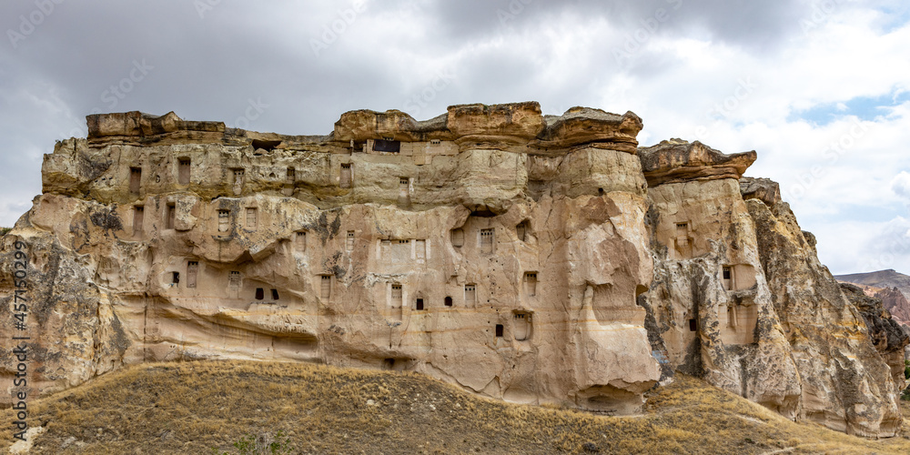 Cappadocia, Turkey - September 1, 2021 – Impressive ancient cave home which had been carved in the Vulcanic rock cliff face of Pigeon Valley at Uchisar in the Cappadocia region of Turkey.