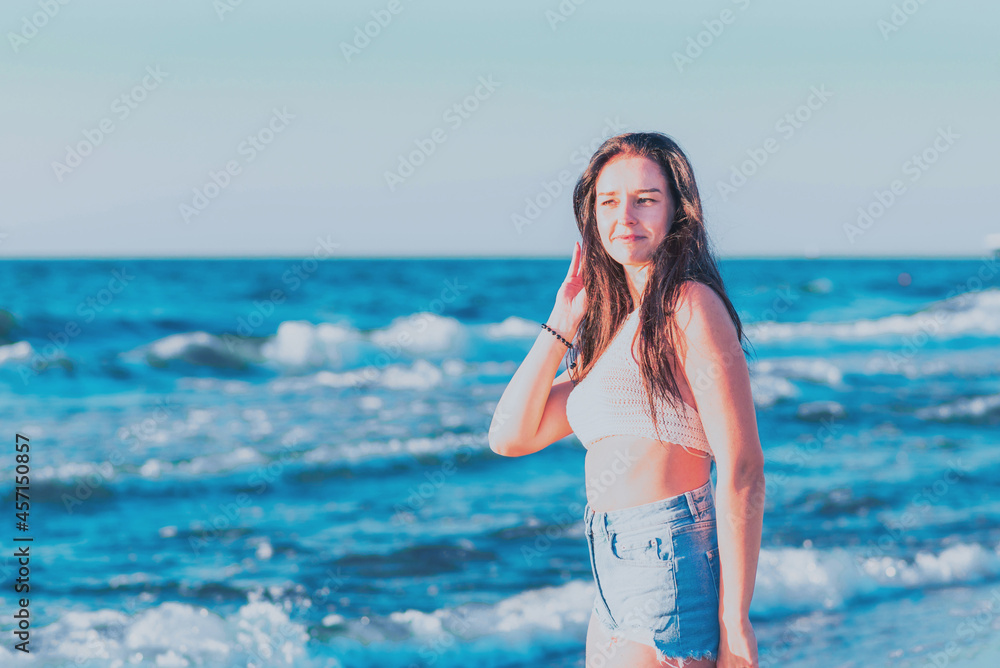 Young woman playing in the sea.woman enjoying in sea water .Cheerful young woman having fun on the summer beach. Young woman playing in the sea.woman enjoying in sea water .Cheerful young woman having fun on the summer beach.
