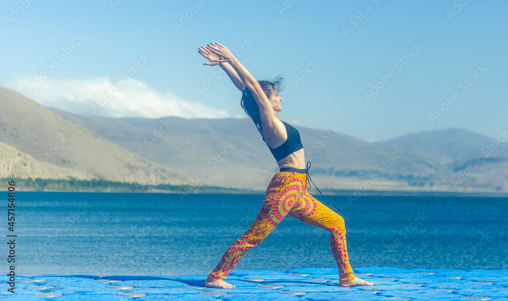 woman doing yoga exercise on the beach, woman relaxing on the beach, woman doing yoga