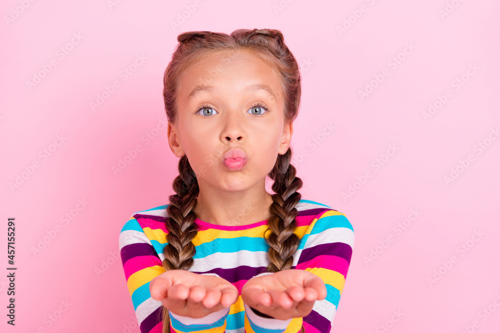 Photo of romantic lovely small lady hold palms send air kiss wear striped shirt isolated pink color background Photo of romantic lovely small lady hold palms send air kiss wear striped shirt isolated pink color background