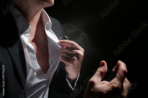 Perfume with man in studio on black background
