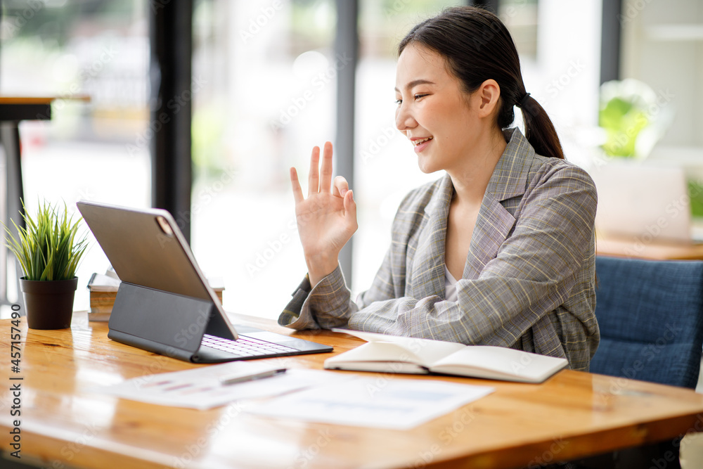 Portrait of Asian young Business woman in having a video call on laptop. Portrait of Asian young Business woman in having a video call on laptop.