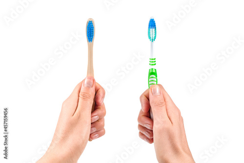 Hands with two toothbrushes on white background.