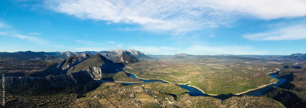 Aerial shot, stunning panoramic view of the Cedrino Lake - Lago del Cedrino surrounded by the mountain range of Supramonte located northeast of the Gennargentu massif. Sardinia, Italy.