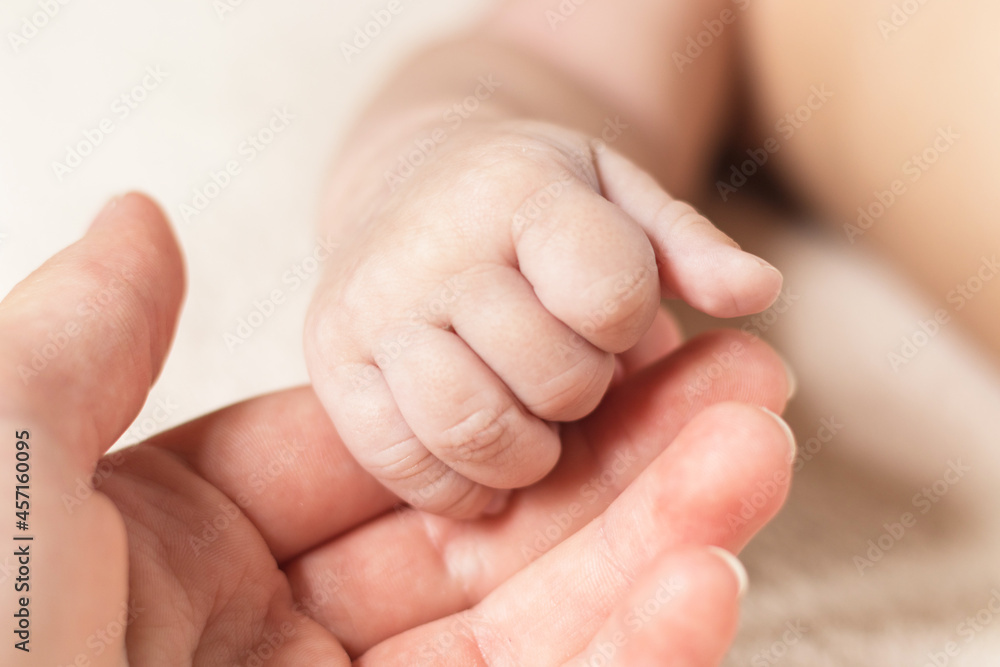 Hand of newborn baby and mother. New generation. Parenting, family and childcare concept. Hand of newborn baby and mother. New generation. Parenting, family and childcare concept.